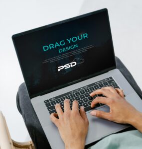 Free Person Using Laptop Mockup PSD