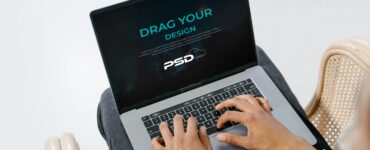 Free Person Using Laptop Mockup PSD